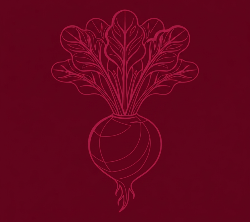 Fresh beetroot with leafy greens on a wooden cutting board